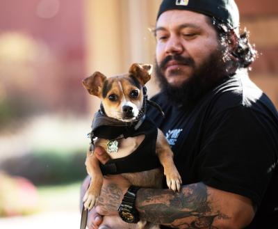 Adopter holding a small dog